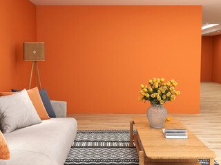 Side view of living room area decoration showing sofa, coffee table with flower vast and orange...