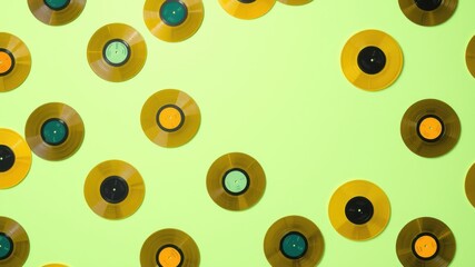 A vibrant collection of vinyl records on a bright green background, showcasing the timeless appeal of analog music.