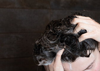 Naklejka premium Woman Rinsing Hair with Water