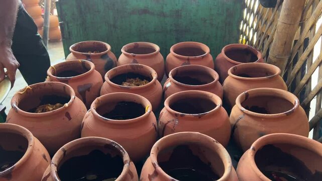 Rows of clay mutton pot or handi for cooking at a hotel in Bihar in India