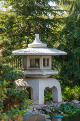 apanese garden in Galitskrgo park in Krasnodar Japanese garden lantern Yukimi-gata or “snow lantern” is squat lantern with wide roof. Lantern against backdrop of greenery of garden.