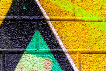 Beautiful brick wall colorful street art graffiti background. Abstract creative spray drawing...