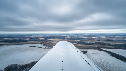 Scenic airplane wing photo with a minimalistic sky, ideal for advertising or storytelling with text overlays.