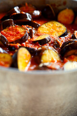 Eggplants with vegetables stewed in tomato sauce. Homemade vegetarian cuisine. Stewed vegetables from fresh home-grown products.   