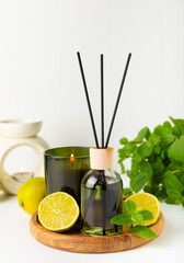 Aromatic reed air freshener on wooden table.Diffuser with natural fruity, floral, spicy...