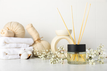 Aromatic reed air freshener on wooden table.Diffuser with natural fruity, floral, spicy aroma.interior scent. Luxury perfume for the home.Orange, lime, coffee, cinnamon, star anise, vanilla and orchid