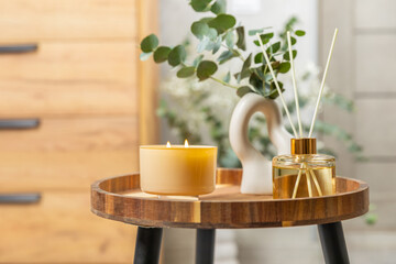 Aromatic reed air freshener on wooden table.Diffuser with natural fruity, floral, spicy aroma.interior scent. Luxury perfume for the home.Orange, lime, coffee, cinnamon, star anise, vanilla and orchid