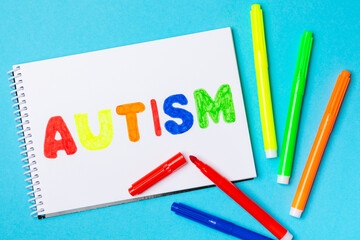 Autism awareness day.2 April world autism awareness day background.Design element.Care Awareness campaign for Autism.AUTISM text with colorful wooden puzzles, letters and cubes.Space for text.Top view