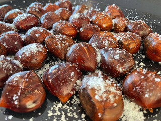 Close-Up of Fresh Chestnuts with Cuttings in Sea Salt