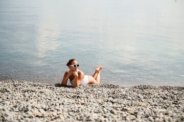 Freelance close up woman hands writing on computer. Well looking middle aged woman typing on laptop keyboard outdoors with beautiful sea view.