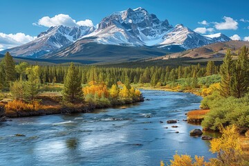 Obraz premium Mountain River Flowing Past Autumn Foliage and Snow-Capped Peaks