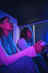 Closeup Young latin couple sit on couch hold joystick play video game spend time together have fun at home on weekend. Lifestyle activity concept.