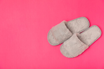Soft slippers on a bright colored background, close-up. House slippers. Comfortable shoes for home. Foot care concept. Home comfort. Space for text. Copy space.
