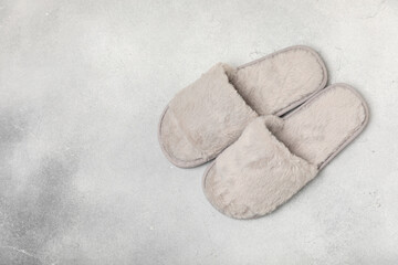 Soft slippers on a bright colored background, close-up. House slippers. Comfortable shoes for home. Foot care concept. Home comfort. Space for text. Copy space.