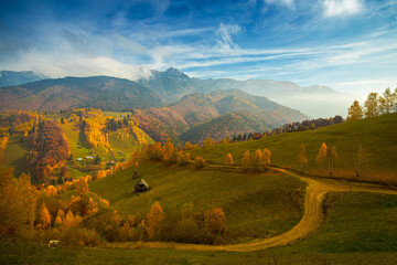 Tomnatic landscape with houses and roads through the Bucegi Mountains
