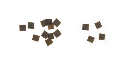 Dry kelp seaweed squares, mini wakame pieces isolated, dried kombu and carrot flakes from ramen