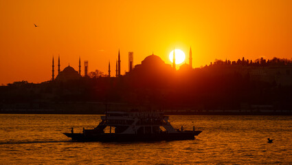 Eminonu city with mosque silhouettes in the background at sunset