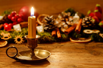 Traditional Christmas garland with moss, apples, cinnamon sticks and dried oranges.