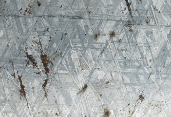 Polished metallic meteorite surface with corrosion over crysal mesh