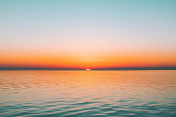Fototapeta premium Scenic Gradient Sunset Sky: Deep Orange to Light Blue with Calm Water Reflection and a Clear Horizon