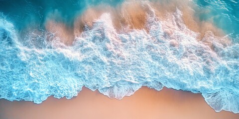 Top view of ocean waves crashing on a sandy shore