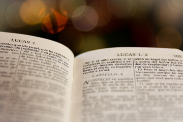 a bible with Luke 2 by a christmas tree