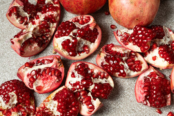 Ripe pomegranates, peeled and whole, the concept of benefits and vitamins in fruit.