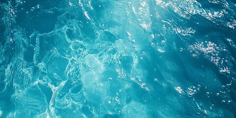 Fototapeta premium Ocean's Surface: A mesmerizing top-down view of azure water, shimmering with sunlight and dancing with gentle ripples. The perfect abstract backdrop for serenity, tranquility.