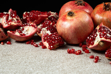 Ripe pomegranates, peeled and whole, place for text