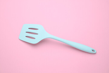 Silicone kitchen spatula on a pink background