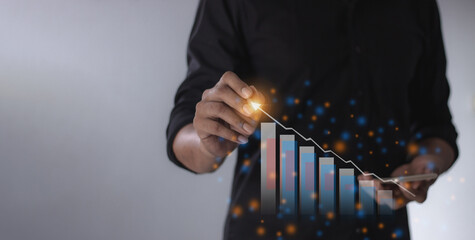 Young man with smartphone mobile hand hold a pen touching to visualize money growth The phone screen displays graphs and charts showing increasing investment and savings trends