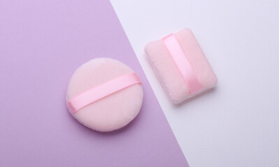 Makeup sponges on purple white background