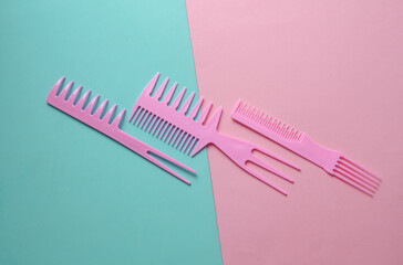 Set of plastic combs on pink blue background.