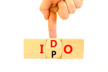 Initial public or DEX offering symbol. Concept words abbreviation IPO or IDO on wooden block....
