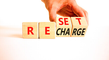 Reset and recharge symbol. Concept words Reset Recharge on beautiful wooden block. Beautiful white...
