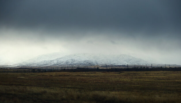 Mountain valley and dark overcast sky in Kazakhstan