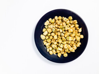 Bandung green peas served on a black plate, isolated on a white background. Perfect for a snack.