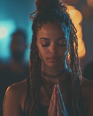Woman With Dreadlocks Practicing Mindfulness in a Dimly Lit Environment During a Meditation Session at Night