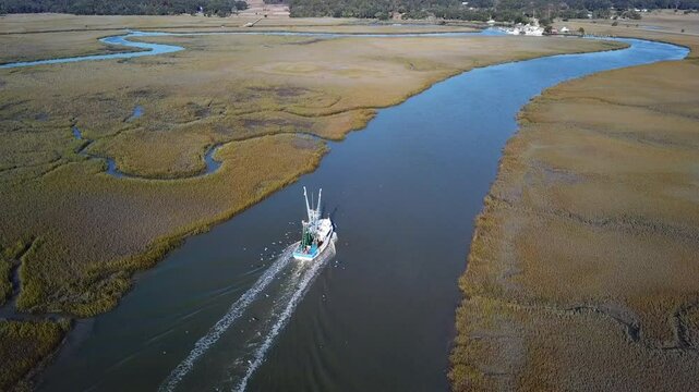 Aerial view of commercial fishing boat coming into port on the Atlantic coast.