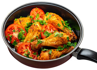 Delicious chicken drumsticks with fresh tomatoes and herbs in a skillet