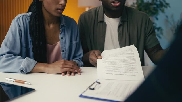 Couple argues with an agent over a rejected insurance claim, feeling frustrated