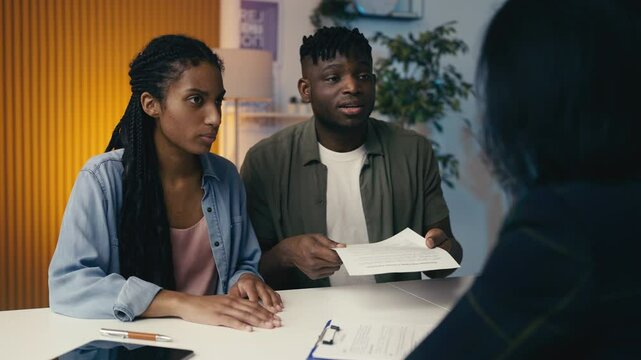 Dissatisfied couple argues with an insurance agent about a denied claim