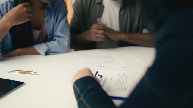 African American couple signs a travel insurance form while planning a trip