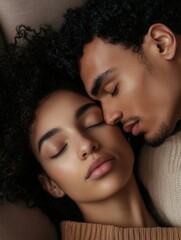 Obraz premium Couple sharing an intimate moment while resting together on a cozy surface with eyes closed in a warm atmosphere during a quiet afternoon