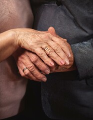 Fototapeta premium A Lifetime of Love: Close-Up of Elderly Hands Clasped Together