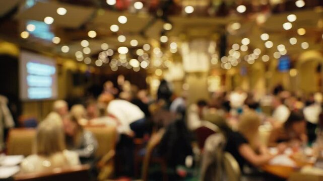 This image depicts a defocused evening event characterized by soft lighting and a lively, engaging atmosphere