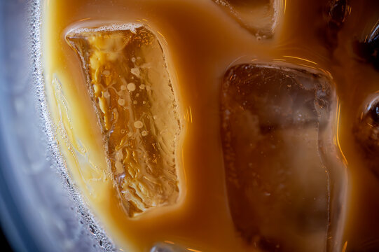 Close-Up of Iced Coffee: Melting Ice Cubes in Creamy Beverage