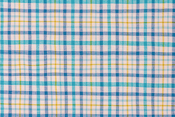 Checkered fabric in blue, white and yellow as a background.