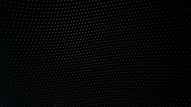 Mesmerizing golden light trails swirl against a black backdrop. Sparkling particles evoke elegance and luxury. Dynamic abstract background video.