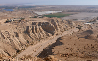 Qumran, an archaeological site located on a dry marl plateau near the northwestern shore of Dead Sea. Caves of Qumran. A dry bed of Qumran stream. Panorama of Qumran National Park. Tourist destination